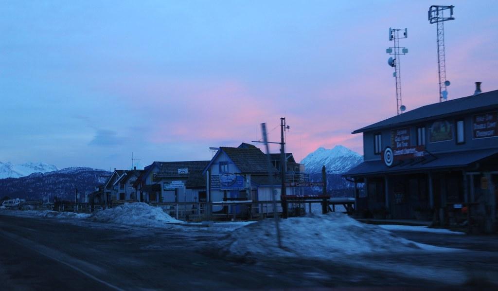 Small businesses closed for the winter along Homer Spit under a pink sunset