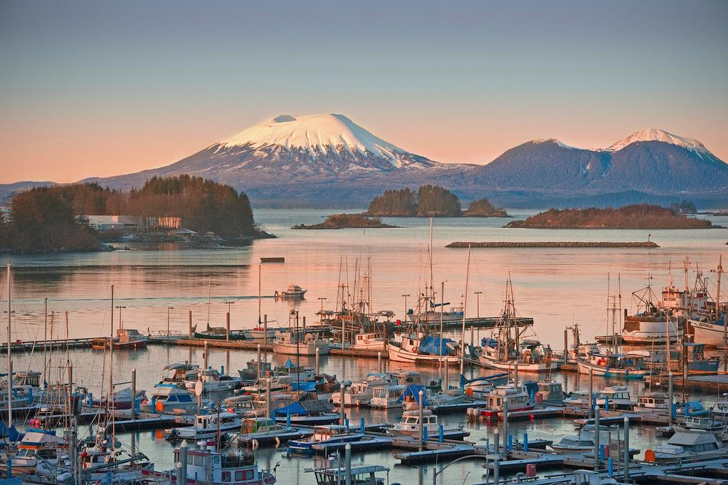 Fishing boats in Sitka harbor with Mount Edgecumbe on the horizon